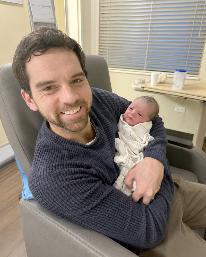 Dr. Jacob B. Thatcher holding a baby